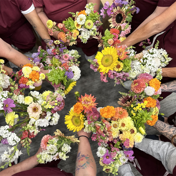 Womens' hands holding colorful bouquets